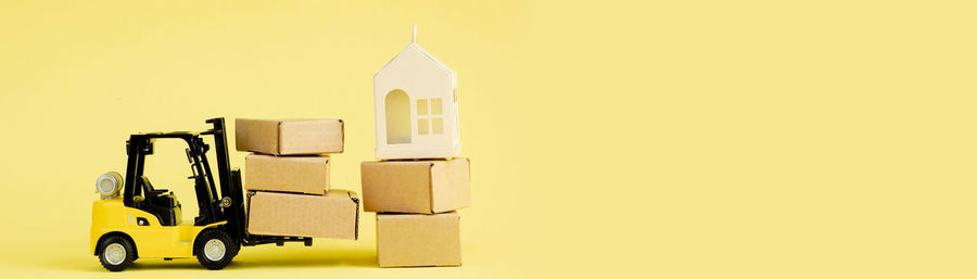 High angle view of christmas presents on yellow background