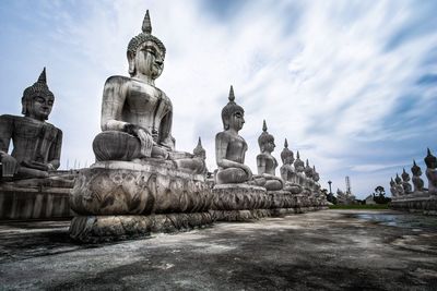 Statue of temple against cloudy sky