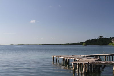 Pier over lake against sky