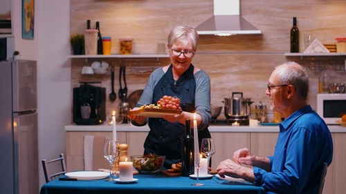 Portrait of senior man preparing food at home