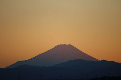 Scenic view of silhouette mt fuji against sky during sunset