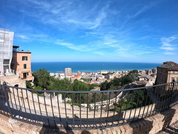 High angle view of townscape by sea against sky