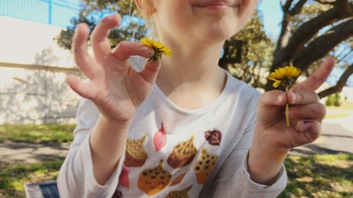 Midsection of girl holding plant