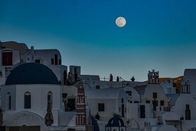 Buildings in city against clear sky