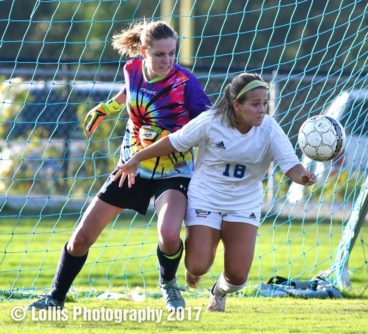 soccer, soccer player, sport, sports uniform, soccer uniform, soccer ball, soccer field, sports clothing, two people, teenager, playing, full length, teenage girls, athlete, grass, goalie, healthy lifestyle, concentration, competition, motion, kicking, net - sports equipment, competitive sport, activity, girls, day, lifestyles, goal, high school student, people, playing field, togetherness, child, soccer shoe, teamwork, outdoors, sports team, adult