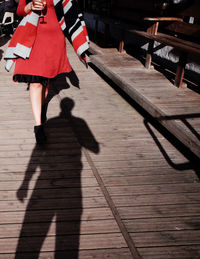 Low section of woman walking on road