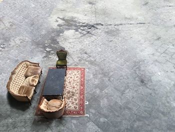 High angle view of sofa with table and carpet arranged on street