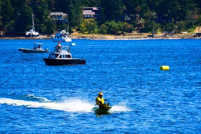 Man riding jet boat in sea