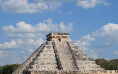 Low angle view of temple against cloudy sky