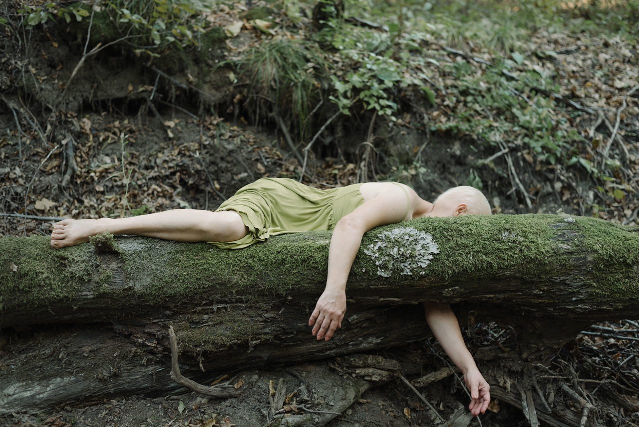 MIDSECTION OF WOMAN LYING ON GROUND