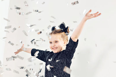 Portrait of happy boy with arms raised