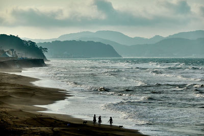 Scenic view of sea and mountains against sky