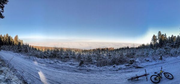 Scenic view of snowcapped field against sky