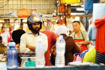 Friends standing at market stall