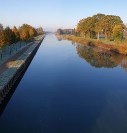 Scenic view of lake against clear blue sky