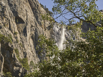 Low angle view of waterfall against sky