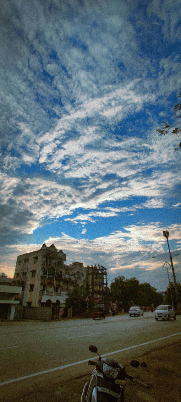 ROAD BY BUILDINGS AGAINST SKY