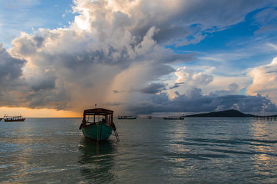 Koh rong island, cambodia at sunrise. strong vibrant colors, boats and ocean