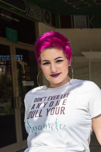 Portrait of beautiful young woman standing outdoors