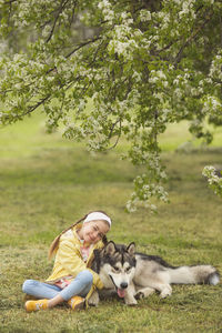 Rear view of man with dog against plants