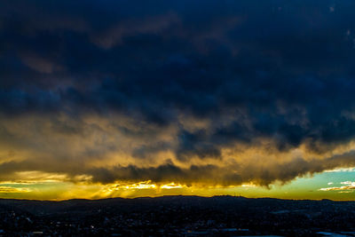 Scenic view of dramatic sky at sunset