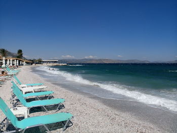 Scenic view of beach against blue sky