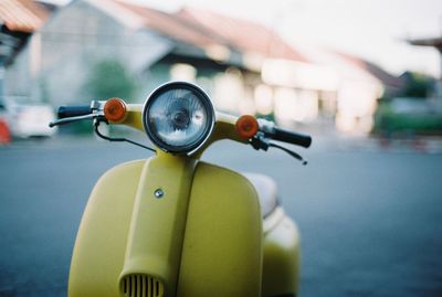 Close-up of old-fashioned scooter parked on road