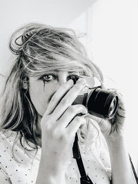 Close-up portrait of man holding camera