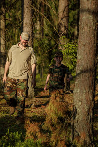 Rear view of man standing in forest