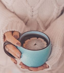 Midsection of woman holding tea cup