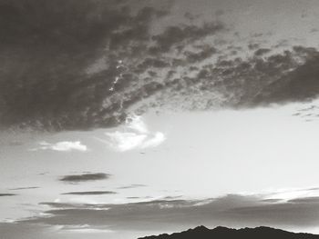 Scenic view of mountains against cloudy sky