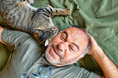 Midsection of woman holding cat