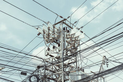 Low angle view of electricity pylon against sky