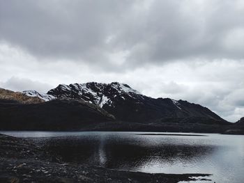 Scenic view of mountains against cloudy sky