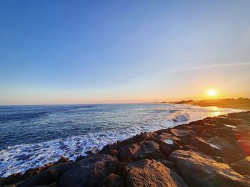 Scenic view of sea against sky during sunset