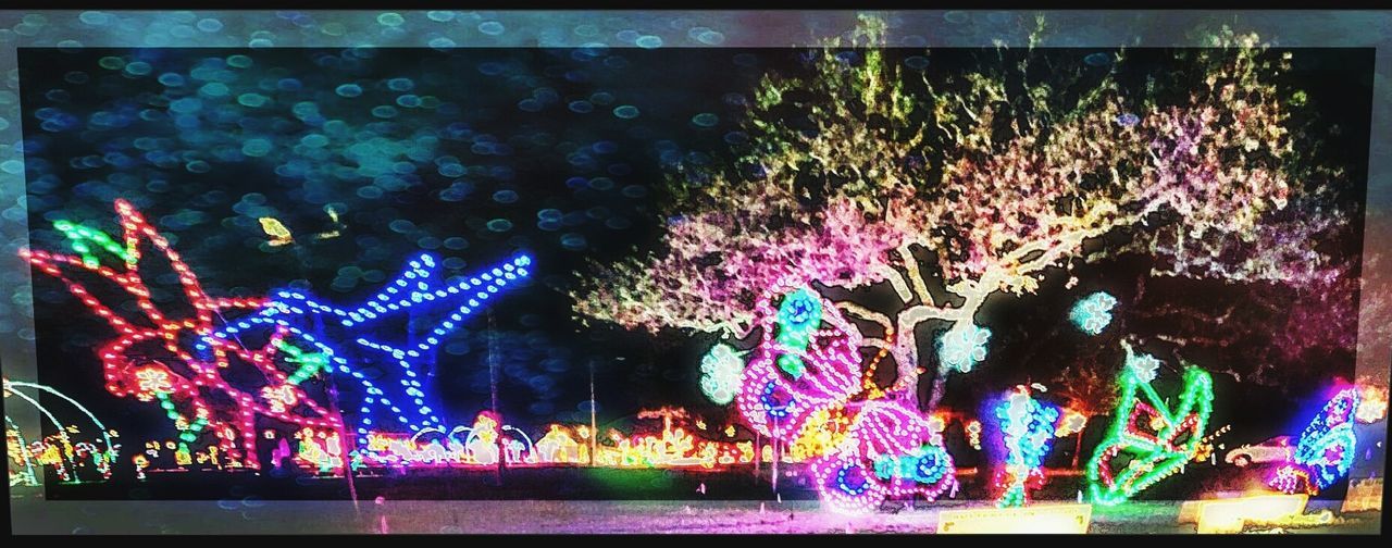 ILLUMINATED CHRISTMAS LIGHTS AT NIGHT DURING FESTIVAL