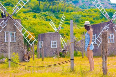 Side view of woman standing at farm