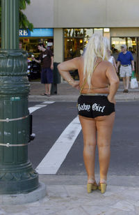 Rear view of woman standing in bus