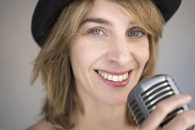 Portrait of smiling woman holding microphone