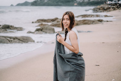 Portrait of woman standing on beach