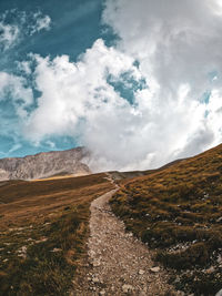 Road by land against sky