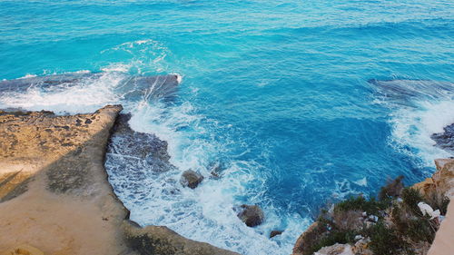 High angle view of water splashing against rocks 