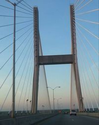 Low angle view of suspension bridge against sky