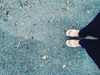 Low section of man standing on road