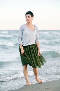 Beautiful woman standing at beach