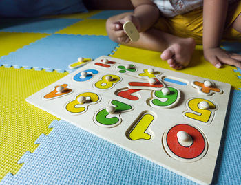 High angle view of boy playing on table