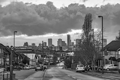 City street by buildings against sky