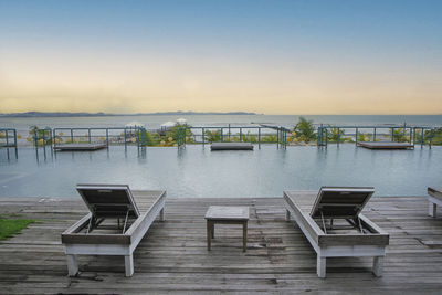 Luxurious tropical pool with sea view. against sky during sunset