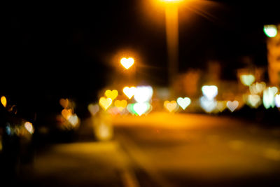 Defocused image of illuminated street at night