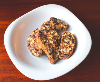 High angle view of dessert in plate on table. biscotti